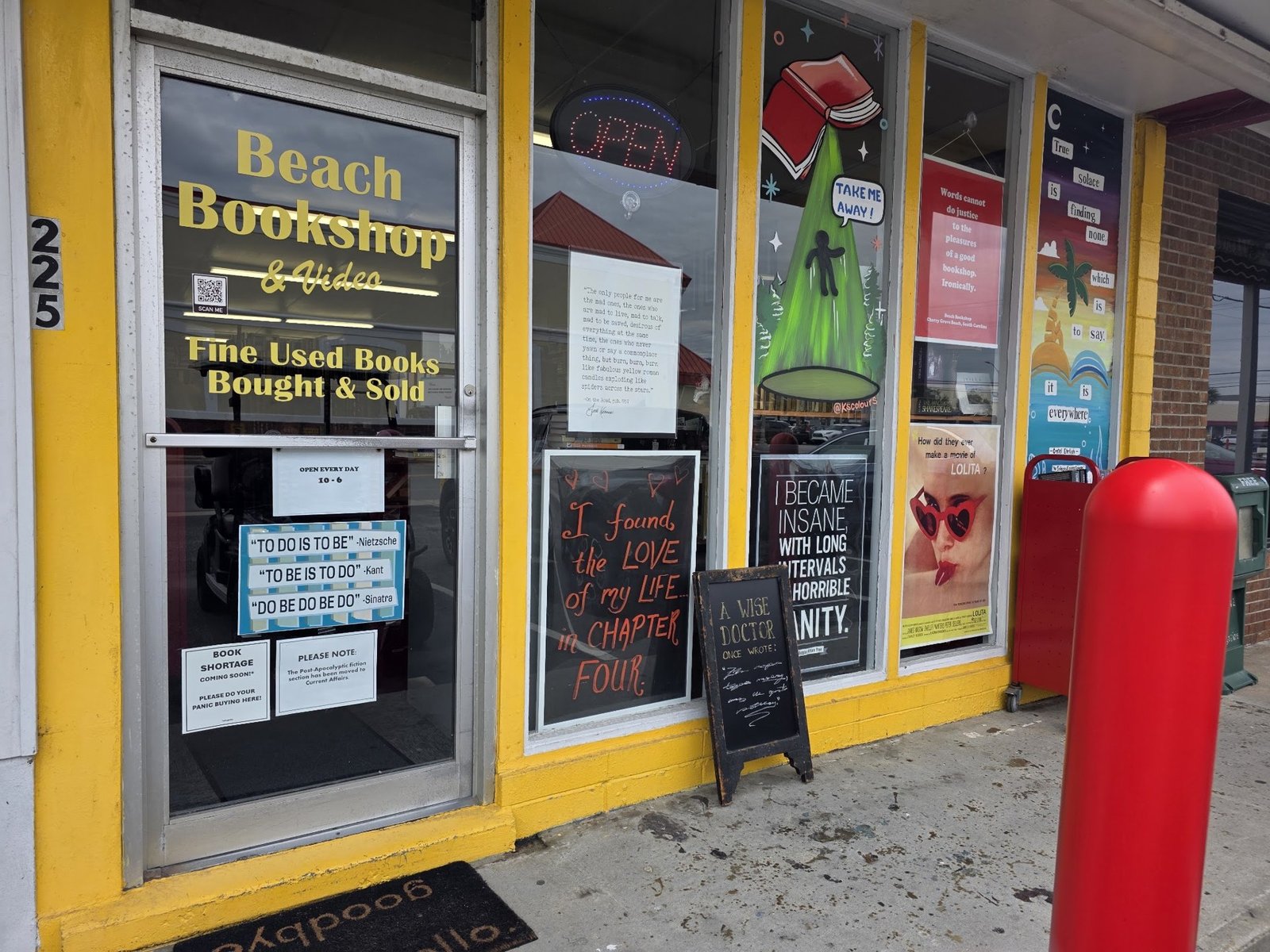 Storefront window with posters and A-frame signs