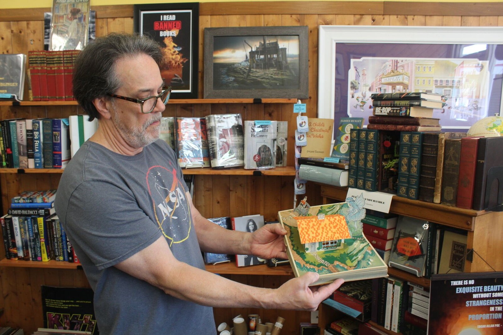 Frank Kaufman, the owner, demonstrating a 1933 Pinocchio pop-up book